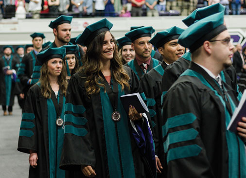 doctor of physical therapy graduates walk in commencement ceremony